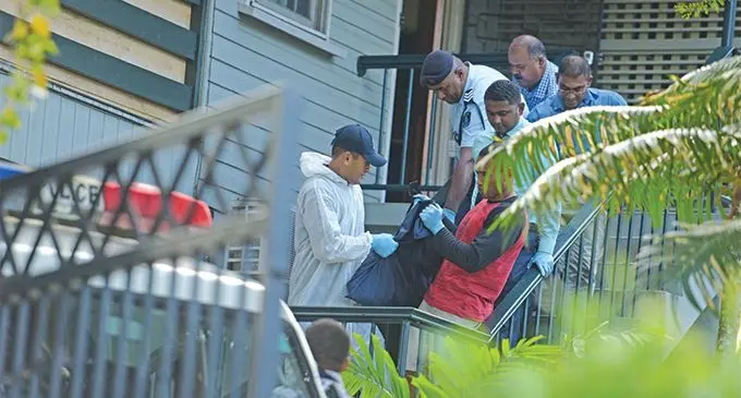 Police officers carry the woman’s body from the couple’s residence at Service Street, Suva on July 23, 2019. Photo: Ronald Kumar