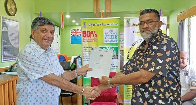 Minister for Sugar Charan Jeath Singh (left) hands over a farm mechanisation grant to Aiyub Khan in Labasa on December 19, 2024. Photo: Shratika Naidu