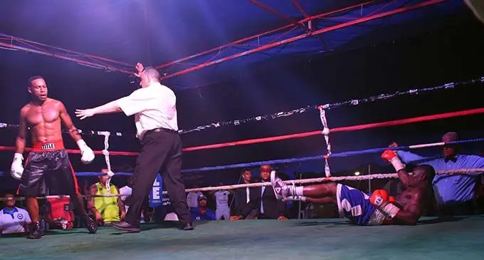 Referee Justine Kennedy (middle) moves in as Joseph Kwadjo struggles to get up from a fierce Savenaca Naliva left hand during their Fiji light-heavyweight title fight at Prince Charles Park, Nadi on October 26, 2019. Naliva won by knockout in the 12th round to claim the title in the South Pacific Boxing Promotions-organised event. Photo: Waisea Nasokia