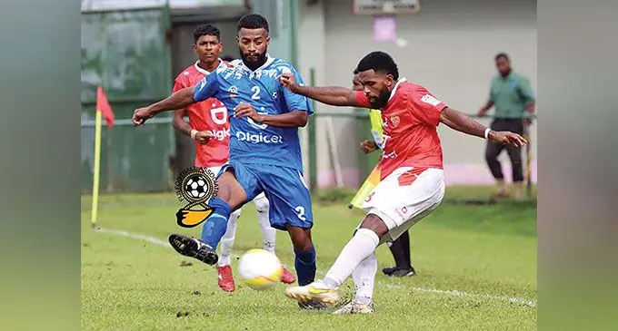 Lautoka’s Epeli Leiroti (centre) tries to block a kick from Rewa’s Setareki Hughes during their Digicel Fiji Premier League match. Photo: Fiji FA Media