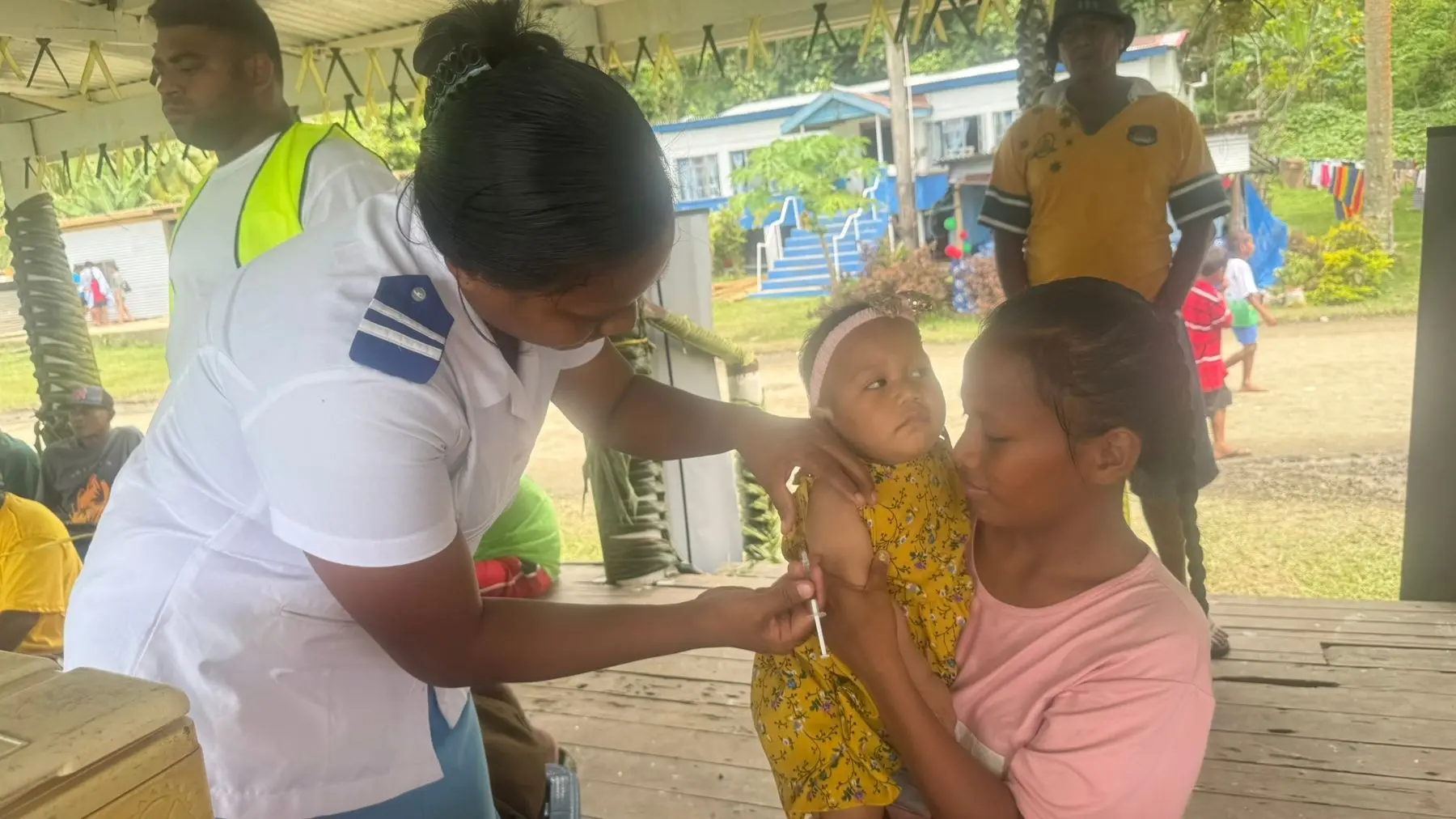 Rabi Health Centre nurse Bibirenga Toaua administers injection to 11 months old Temimitong Etira held by her mom Maria Ewekia, 22 during the 80th anniversary celebrations of the arrival of the Banabans on Rabi Island.