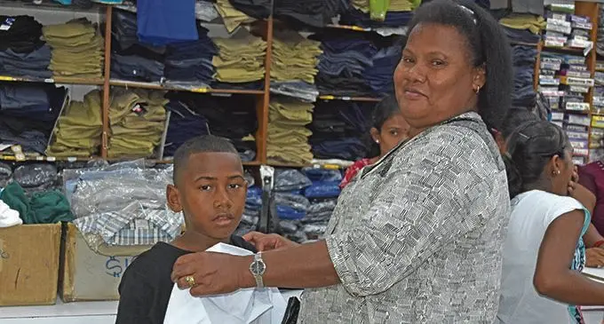 Aunt Seokaveti Kaususu helps her nephew Sekove Malumu with a uniform during their back  to school shopping at Janta Store in Labasa on January 2, 2021.  