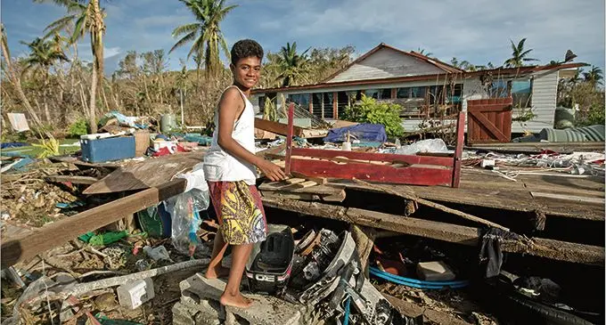 Vaseva Daumaka shows her damaged house and destroyed belongings after a category five cyclone hit her island home.   Photo: UNICEF Pacific