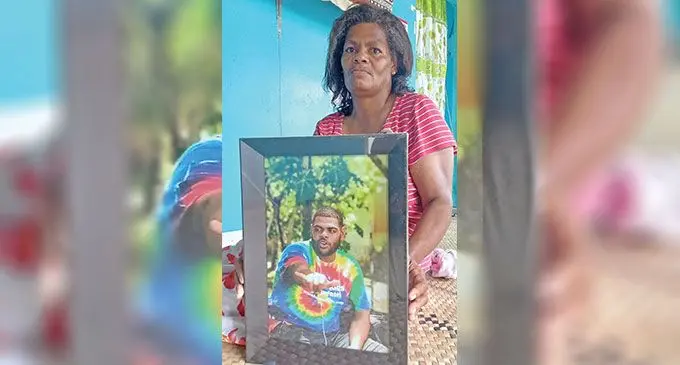 Teresia Ema at the family home in Lami on April 7, 2023, holding a picture of her late son, Lemeki Duidomo who was killed a year ago. Photo: Ronald Kumar