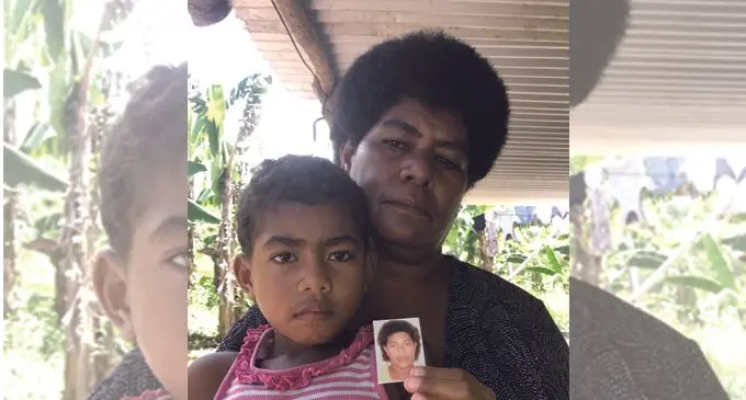 Wainikiti Kemea, 5, holds the photo of her mum, while grandmother Viame Raluve looks on at their home in Semo Village, Nadroga, on February 23, 2018. Photo: Waisea Nasokia