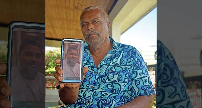 Lila Dhar holds up a picture of his late son Prashneel Praneel Prasad at his home in Carreras Road, Votualevu, Nadi, on December 6,2022. Photo: Salote Qalubau