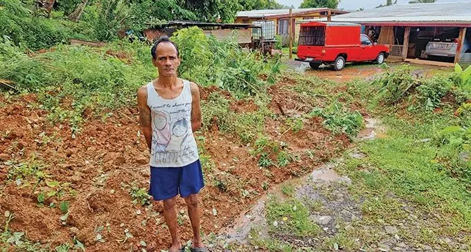 Vunika resident, Rishi Deo, standing in front of the pile of vegetation, debris and soil materials brought by the landslide in Vunika, Labasa on January 11, 2022. Photo: Sampras Anand