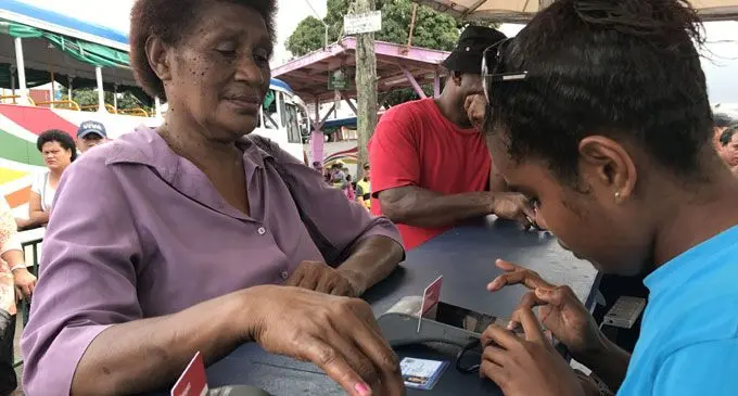 Salinieta Nekebau of Lami (left), gets her e-transport card registration done by Fane Bui at the Suva Bus stand on September 28, 2017. Photo: Ronald Kumar