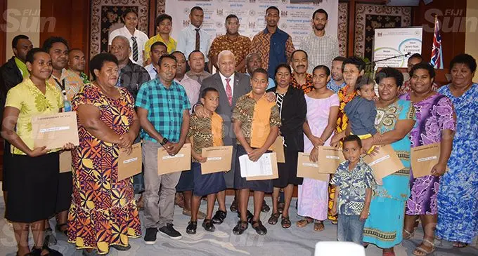 Prime Minister Voreqe Bainimarama with recipients of workplace compensation at the Civic Centre on September 2, 2020. Photo: Ronald Kumar
