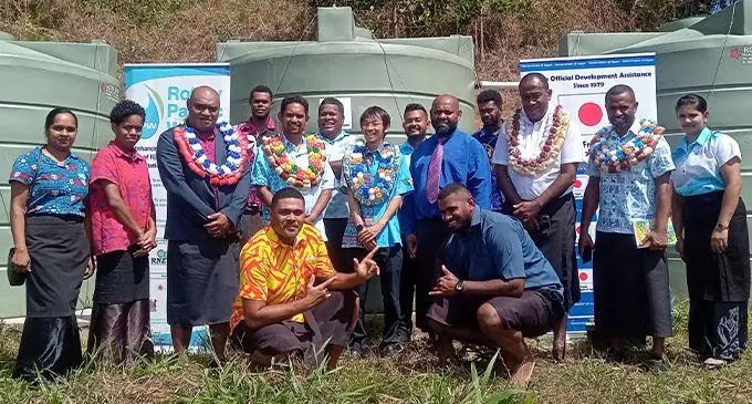Embassy of Japan’s Second Secretary, Tanaka Yoshiaki (standing centre) with stakeholders and villagers of Bavu village during the handover of the new water tanks. Photo: Embassy of Japan