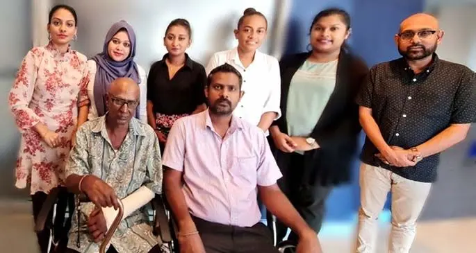 Accident Compensation Commission of Fiji chief executive officer, Parvez Akbar (right) with compensation recipients and their families. Photo: Accident Compensation Commission of Fiji