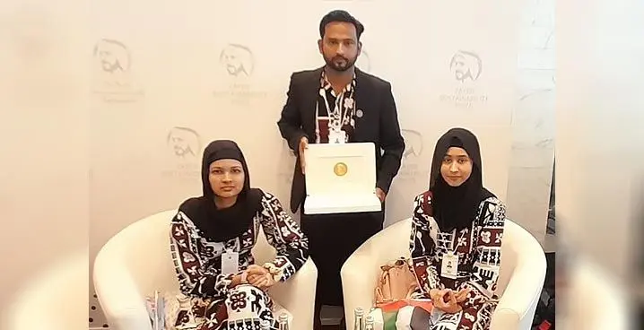 Team Kamil Muslim College in Dubai, Nawaila Nafisha Ali (left), Aqeelah Laylaa Ali (right) with their teacher, Rinal Prasad after winning the Zayed Sustainability Prize, under the Global High Schools category.