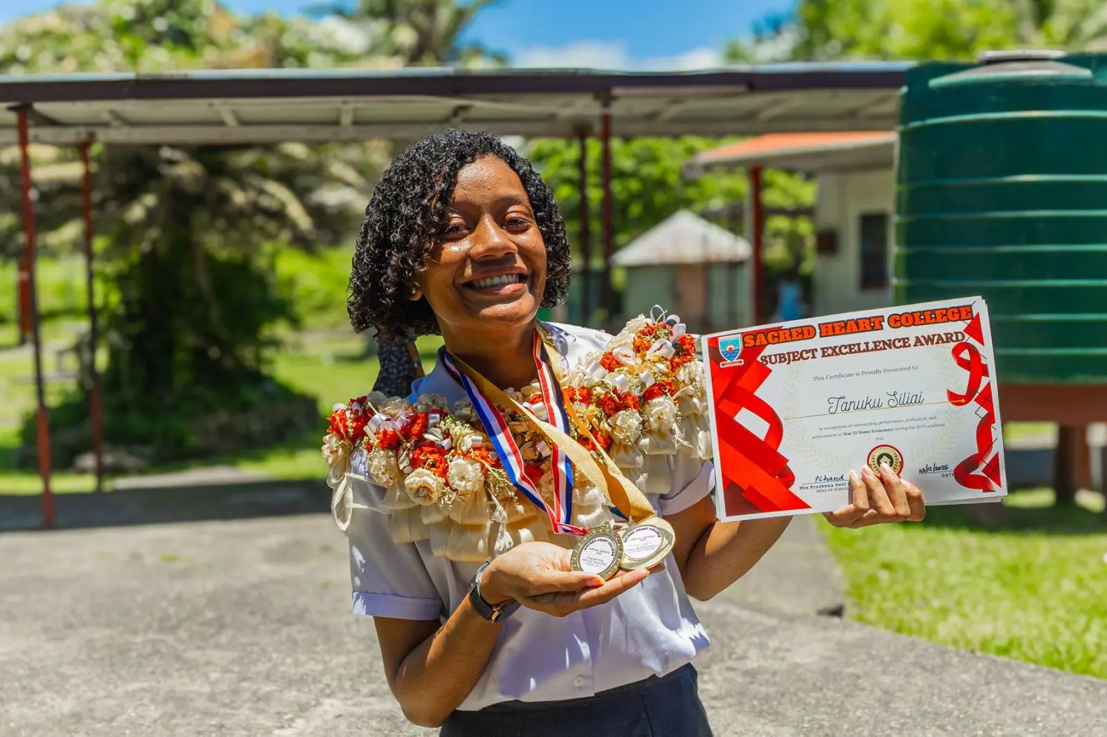 Sacred Heart College's Home Economics top achiever Tanuku Siliai with her awards at Sacred Heart College on December 3, 2025.