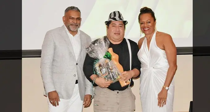Minister for Commerce, Trade, Tourism and Transport Faiyaz Koya with Fiji Fashion Week managing director, Ellen Knight-Whippy, congratulated the award winner for Legend of Fiji Fashion Week, Hupfeld Hoerder, during the FFW anniversary and awards night at the Grand Pacific Hotel in Suva. Photo: Ministry of Commerce Trade, Tourism and Transport