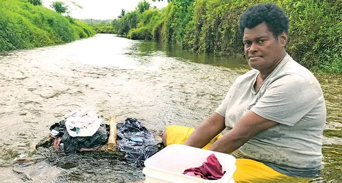 Masilini Liku, 55, enjoys doing family laundry in the clear Waisuluboca Creek without having to worry about debris flowing from upstream from the gravel extraction works. Photo: Kelera Sovasiga