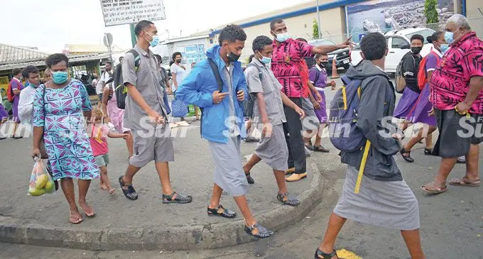 Suva Grammar School teacher Navitalai Naivalu (in pink on the left) directing students to their buses at the Suva Busstand on 25 February, 2022. Photo: Ronald Kumar