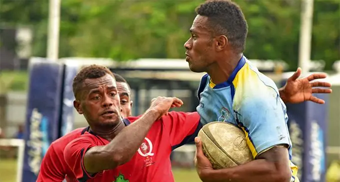 Warwick Ratu Filise's Rautube Vasu (right) fends off a tackle from Namuaniwaqa in pool play at the Uluinakau 7s at Prince Charles Park in Nadi on March 8, 2019. Photo: Waisea Nasokia