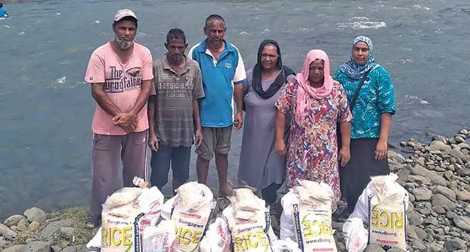 Being Helping Hands Fiji Labasa co-ordinator Shainaz Bano (right) with recipients Rukshana Begum and Aminat Bi and their family members in Vunimoli, Labasa on April 7, 2022.