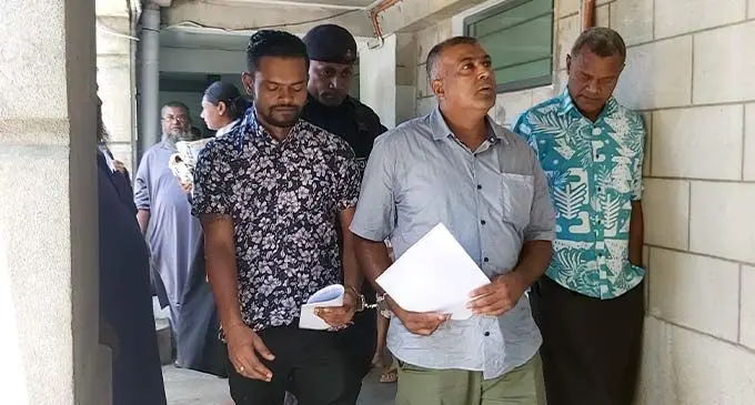 Karim Begg (handcuffed right) and Ronil Chand (handcuffed left) outside the High Court in Suva after their sentence on December 6, 2022. Photo: Ashna Kumar