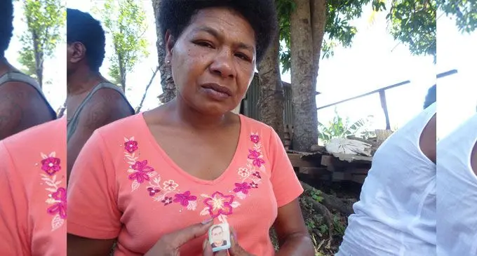 Mereseini Vueti holding a picture which features her late husband (circled). Photo: Karalaini Tavi 
