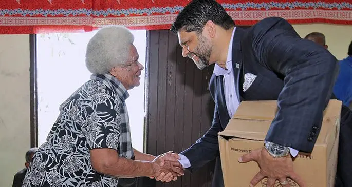Venina Nacolarara receives her cooking stove from Attorney-General and Minister for Economy Aiyaz Sayed-Khaiyum yesterday. Photo: DEPTFO News