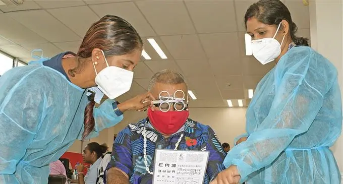 Malakai Gucake gets his eye checked by CWM eye care nurse, Vikashni Latchmi (left) and Ranjeeta Devi as world sight day was marked on 14, October 2021.Photo: Ronald Kumar.