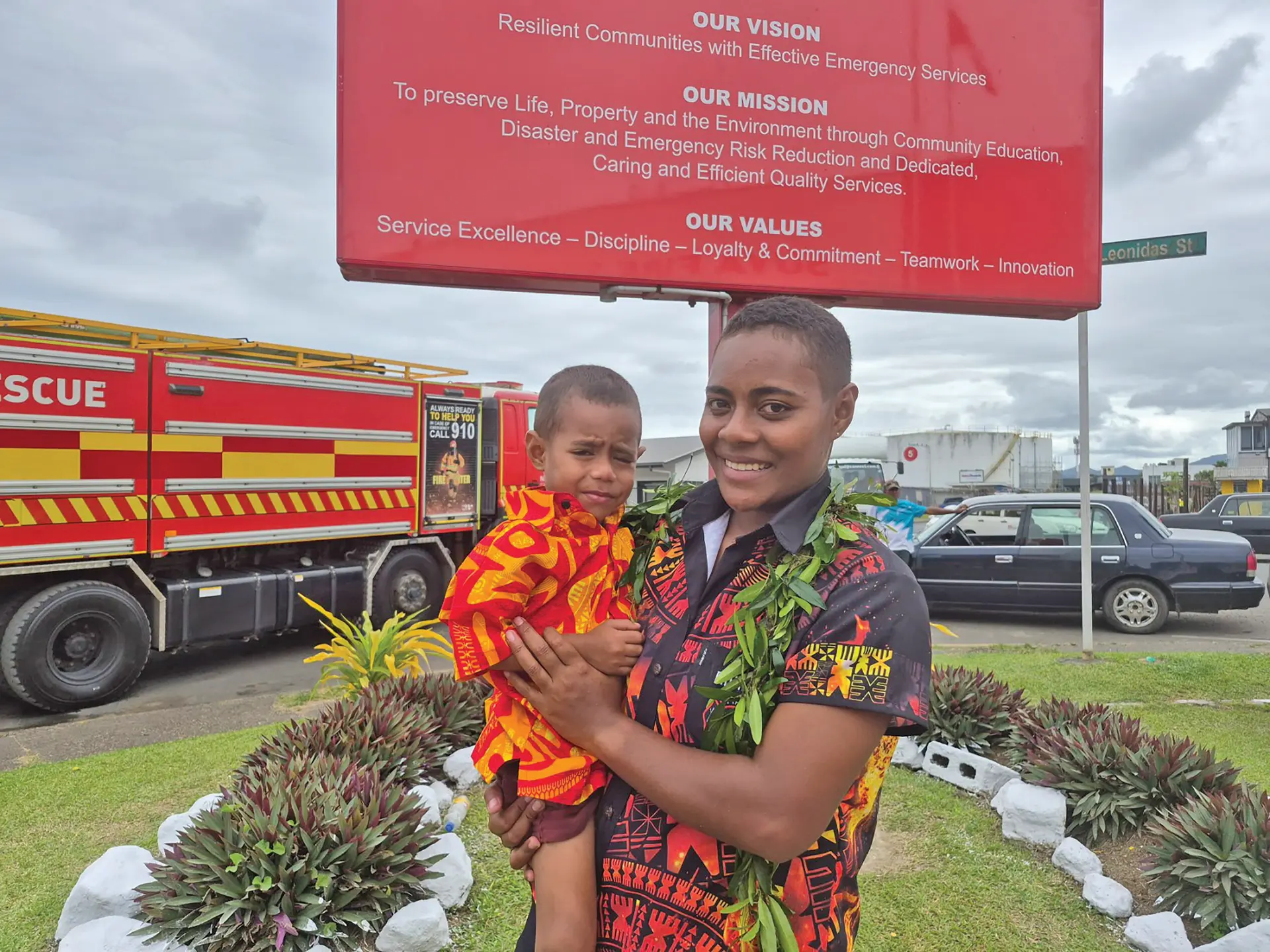 Firefighter Ulamila Ratulevu holding her son on May 13, 2026.
