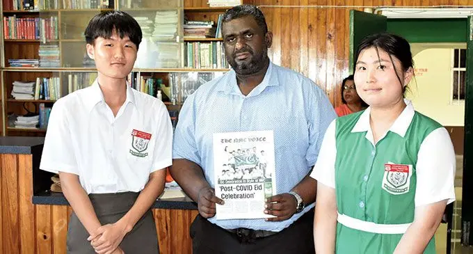 Chungki Lee, and Principal Sheron Haroon with the newspaper.  Photo: Waisea Nasokia 
