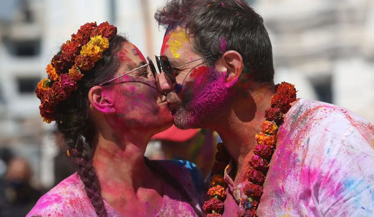 A couple kiss each other during the celebration of Holi Festival in Kathmandu, capital of Nepal, March 9, 2020. (Photo by Sunil Sharma/Xinhua) 