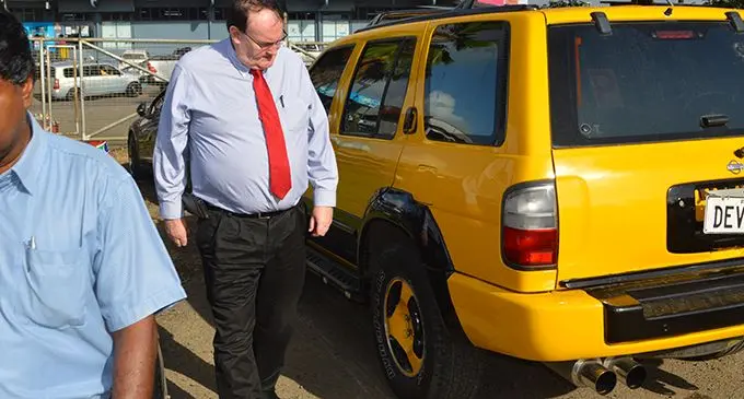 LTA CEO Mr. Samuel Simpson inspects a vehicle modified with a loud exhaust pipe at LTA Valelevu impounding yard.