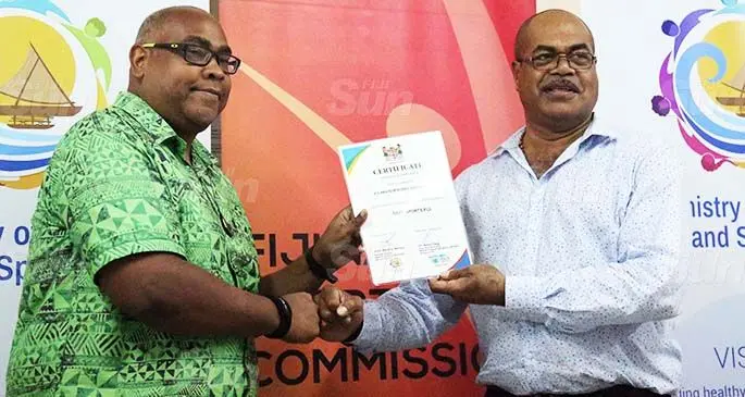 Fiji Amateur Boxing Association board member Martin Burrows (left) receiving their Safe Fiji Sports Accreditation from Permanent Secretary of Youth and Sports Maritino Nemani at the Nasoqo House, Suva on July 9,2020. Photo: Sereana Salalo