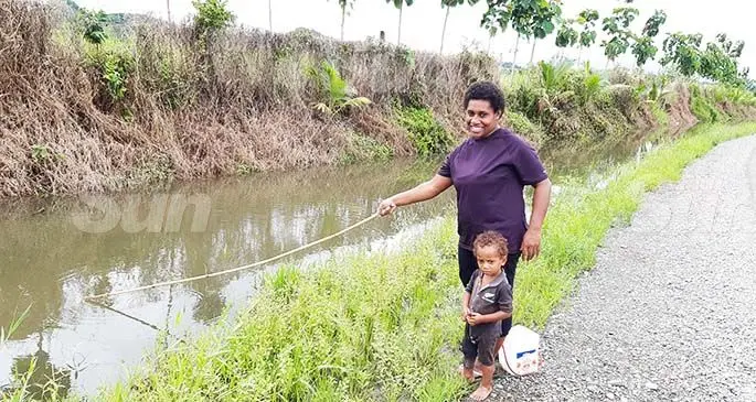 Lusiana Lotu with her child fishing in a creek in Navua on December 28, 2019. Photo: Ronald Kumar