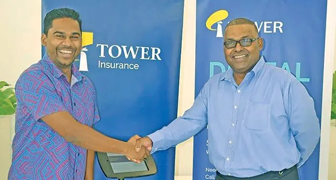 Asco Motors acting chief executive officer Ronald Kumar (left)with Tower Insurance country manager Joseph Magnus during the launch of the digital kiosk at the Asco Motors shownroom in Nabua.