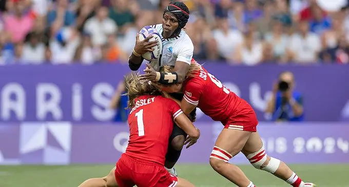 Team Fiji 7s women’s captain Raijeli Daveua is stopped by the Canadian players. Photo: ONOC