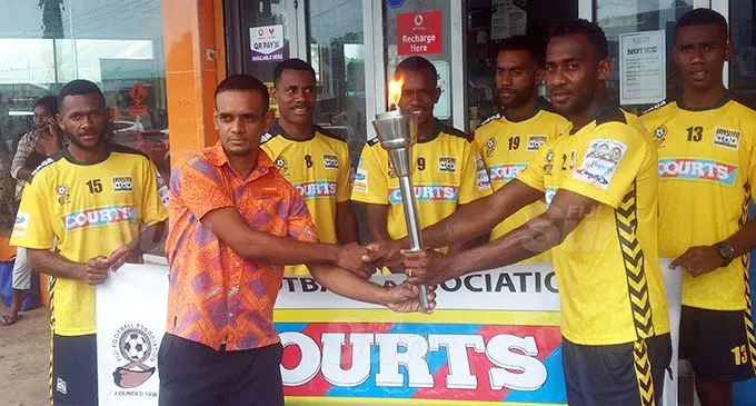 Tavua football players hand over the Courts Interdistrict Championship Torch to Courts Tavua assistant retail manager Nilesh Sharma on October 5, 2020. Photo: Susana Hirst-Tuilau