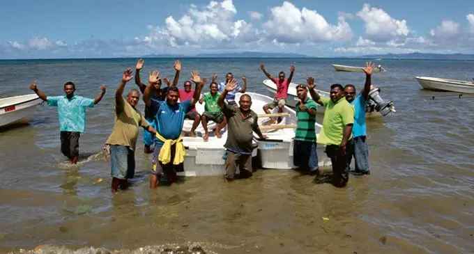 Villagers with the two boats on March 11, 2018.