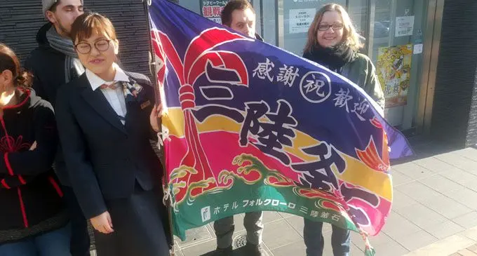   Fishing boat flags are waved as a show of support for the Kamaishi Seawaves rugby team. The flag symbolises the port town as it is waved from the stands. Photo: Leone Cabenatabuai