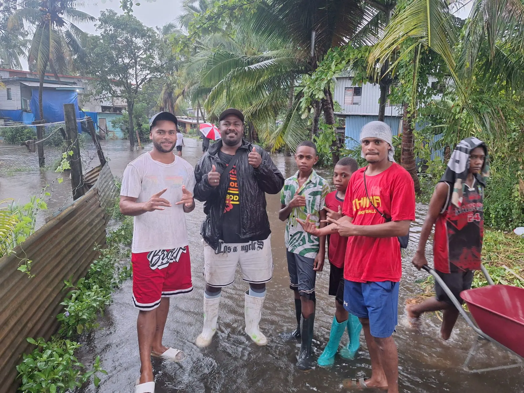 Residents wade through floodwaters at Nawajikuma settlement in Nadi as heavy rain inundated homes.