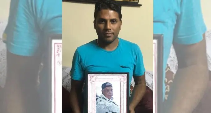 Mohammed Iftikar Ali with a portrait of his grandfather, the late Ashraf Ali Razat.   Photo: Inoke Rabonu