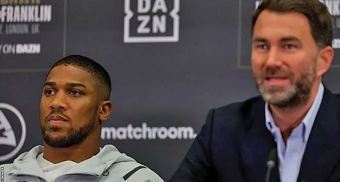 Anthony Joshua (left) seated beside Eddie Hearn, looked sullen during the press conference