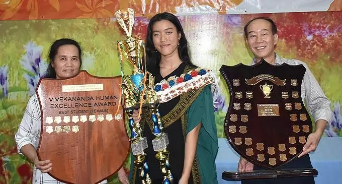 From left: Mum Betsy Liu, Swami Vivekananda College DUX Zu Feng Liu and Dad Jason Liu after the college graduation on December 9, 20222. Photo: Waisea Nasokia