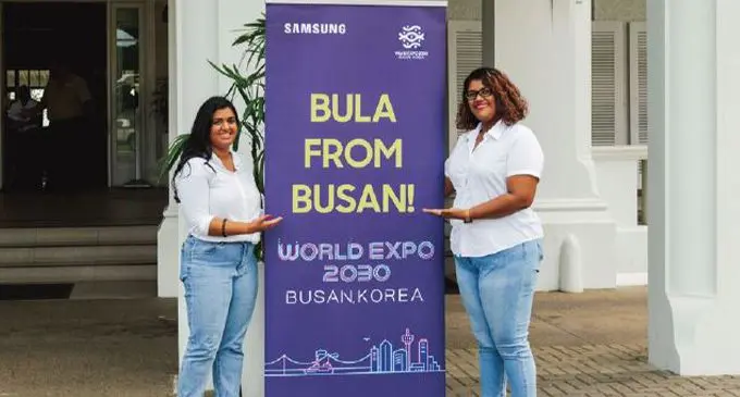 "Bula From Busan" marketing team pose with their outdoor signage outside GPH. Photo: Samsung Electronics Team