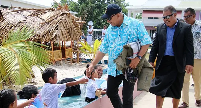 Prime Minister Voreqe Bainimarama greeted by women and children of Tuvalu in a pool of water at Funafuti on August 11, 2019. The women and children in the water was a  demonstration that the people of Tuvalu are threatened by climate change and the rising sea water.  Photo: Pacific Islands Forum Secretariat