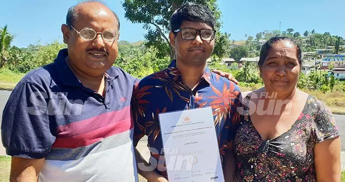 Natabua High School student, Justin Kumar (middle) with his parents Navindra and Angeline outside their home in Lautoka on October 8, 2021. Photo: Nicolette Chambers