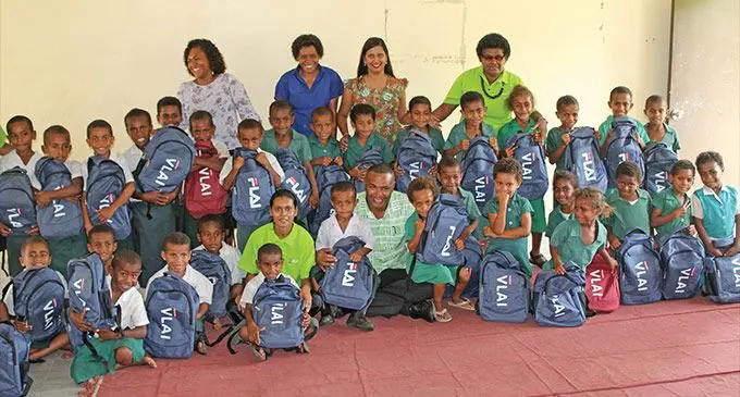 Children receiving stationery packs from BSP Financial Group Limited