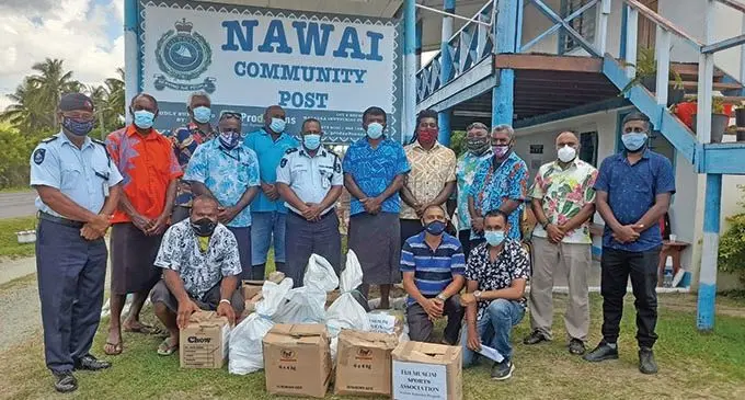 Mouzeem Safeel Mohammed (far right) with Sergeant Penijamini Vukivou (standing far left) and divisional manager for community policing West Superintendent of Police SP Lepani Liga (middle) with the village heads and CPC leaders at Nawai Community Post in Nadi. Photo: Mereleki Nai