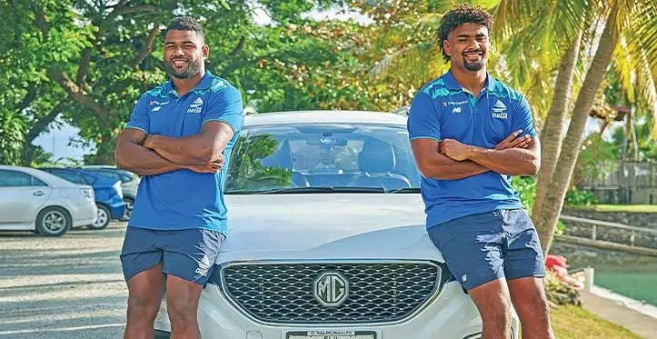 Swire Shipping Fijian Drua flanker Raikabula Momoedonu (left) and lock Isoa Nasilasila with their official motor vehicle sponsored by MG distributor Pala’s Group. Photo: Fijian Drua Media