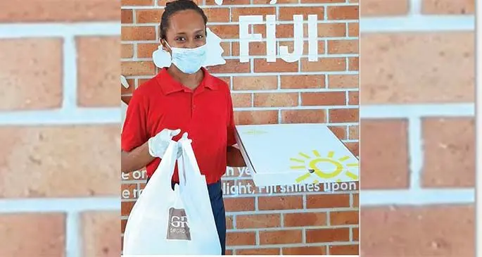 Karalaini Vasukivcakau of Grace Road Kitchen’s Fierce Chicken outlet at Flagstaff with food orders ready for delivery.
