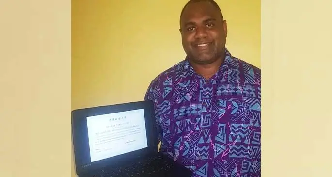Joseva Racaca with an eCopy of his Master’s Degree certificate.