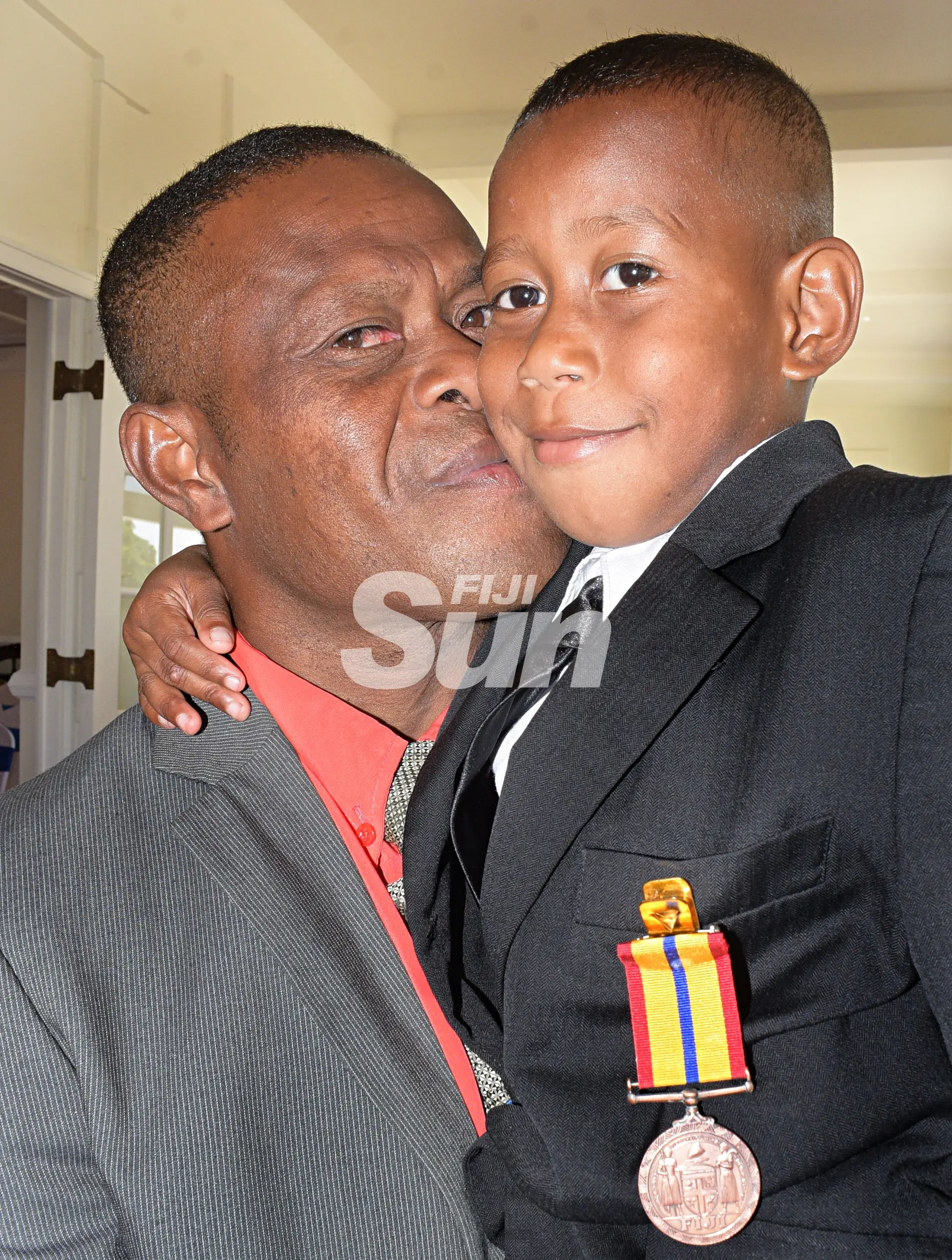 Five-year old Aqoriniasi Dreu is hugged by his father, Bonefasio Turiva after receiving bravery medal from President Major-General (Ret’d)Jioji Konrote during Order of Fiji investiture ceremony at State House on November 29, 2019. Photo: Ronald Kumar.